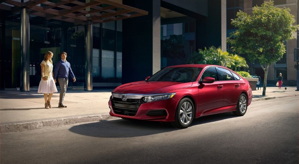 A red 2020 Honda Accord parked by a city curb after visiting a dealer with a used Honda for sale near Union City.