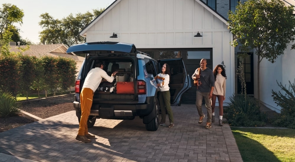 A blue 2025 Toyota Land Cruiser for sale is shown on a driveway.