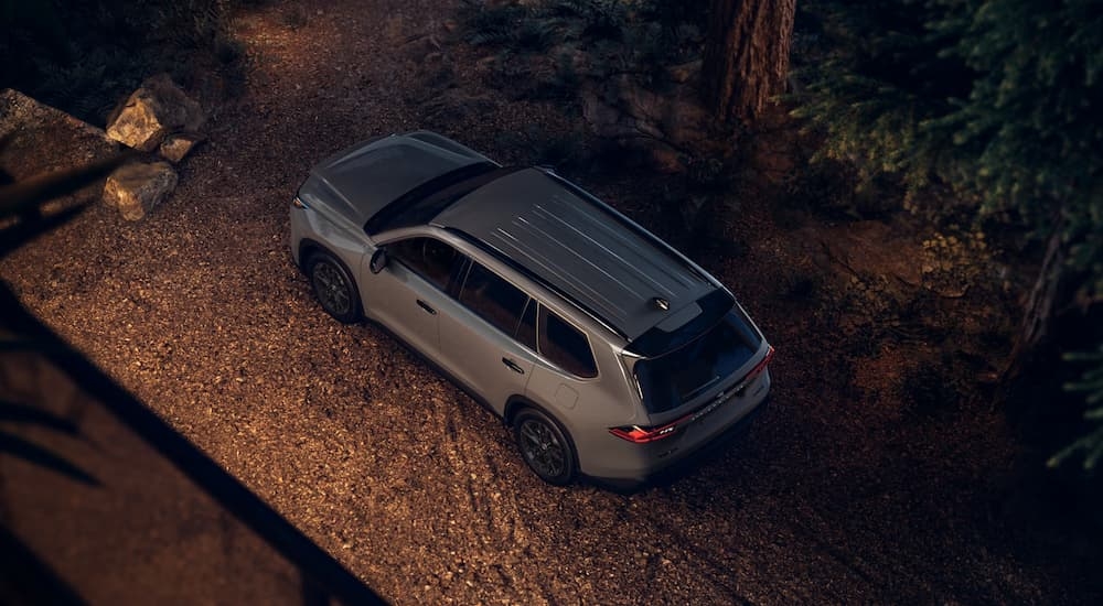 A high angle view of a grey 2025 Toyota Grand Highlander parked off-road.