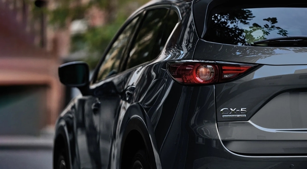 A grey 2020 Mazda CX-5 is parked at a Mazda dealer.