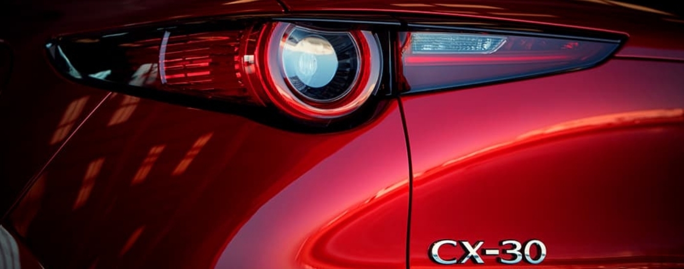 A close-up shows the driving side taillight on a red 2020 Mazda CX-30 for sale.