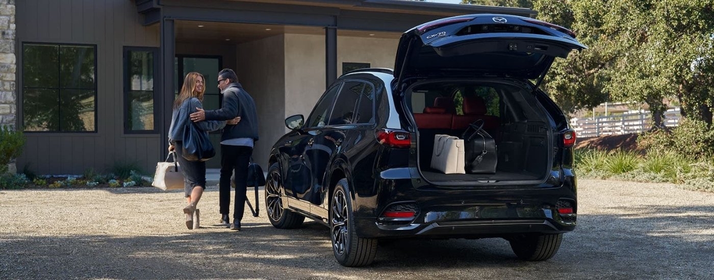 A black 2025 Mazda CX-70 is parked on a driveway.