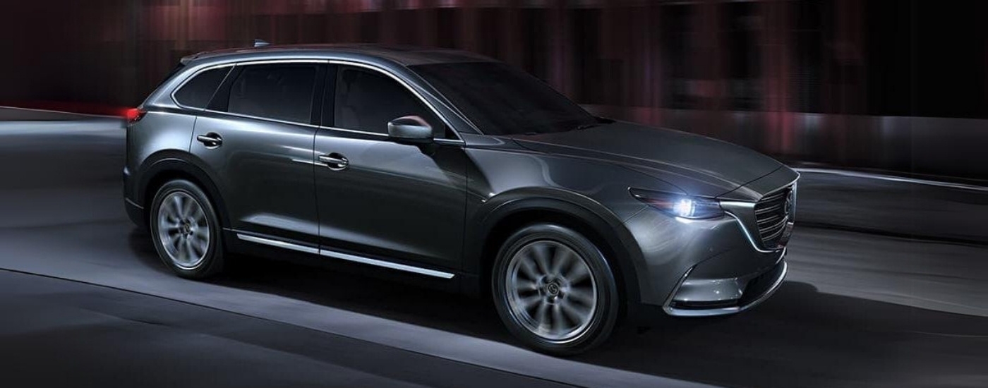 A grey 2019 Mazda CX-9 is driving to a used Mazda dealer near Atascocita.