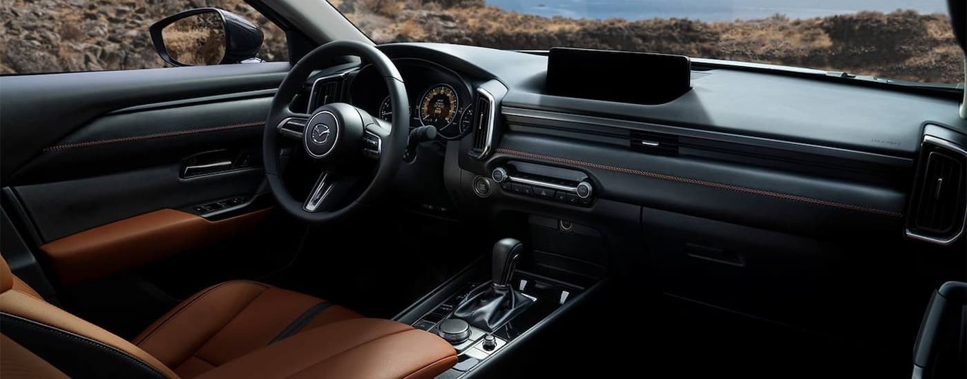 The black and brown leather interior is shown in a 2023 Mazda CX-50.