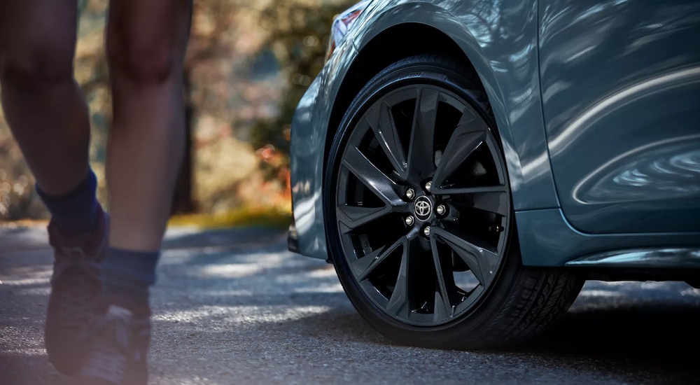 A close-up on the front wheel of a grey 2025 Toyota Corolla.