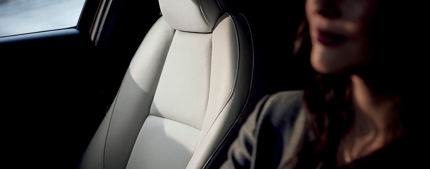 A person driving in a 2023 Mazda CX-30, a popular used Mazda for sale.