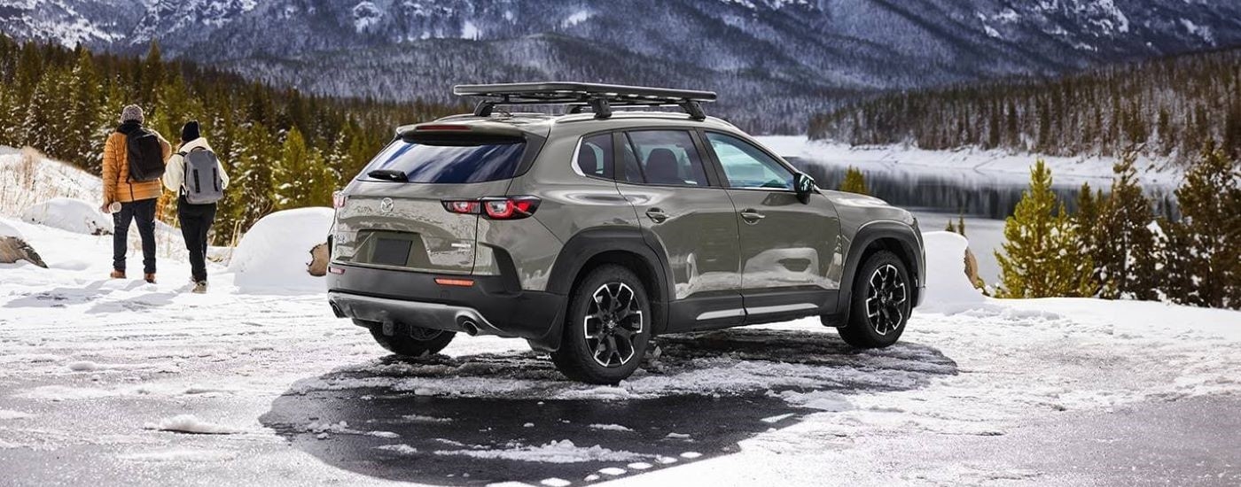 Rear view of a 2024 Mazda CX-50 Meridian parked on icy terrain.