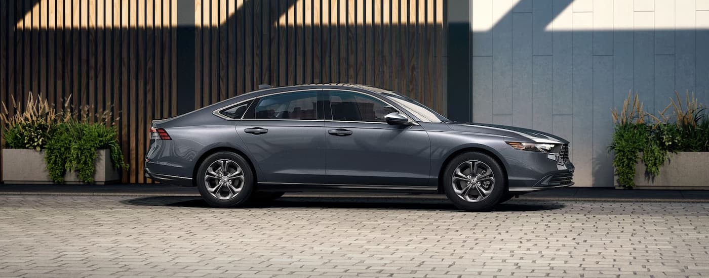 A grey 2025 Honda Accord parked on a brick road.
