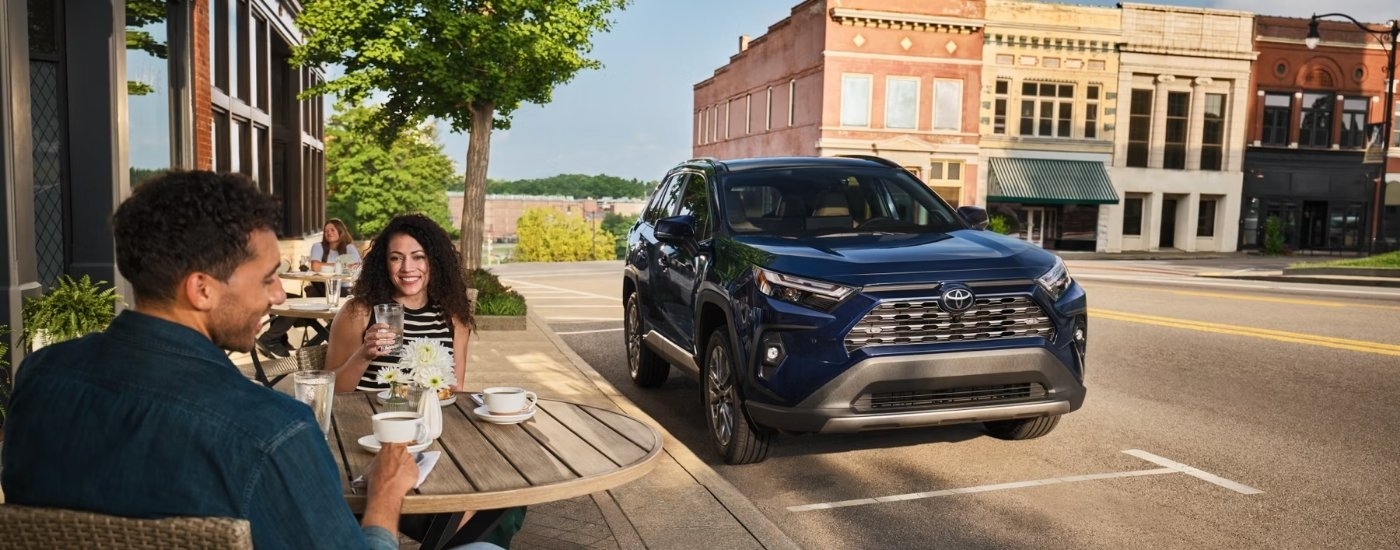 Dark blue 2025 Toyota RAV4 for sale in Westminister at a cafe.