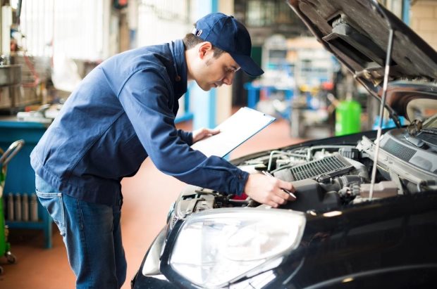 Technician performing engine service