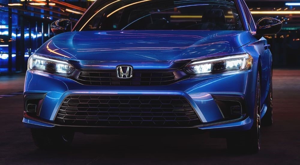 Blue used 2023 Honda Civic for sale near North Bergen parked at night.