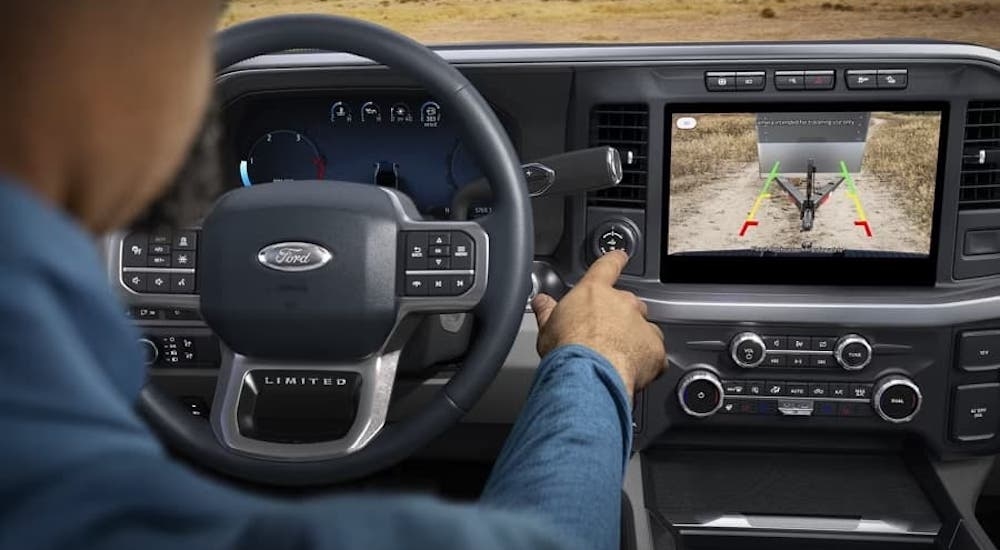 A driver using the dashboard interface in a 2023 Ford F-350.
