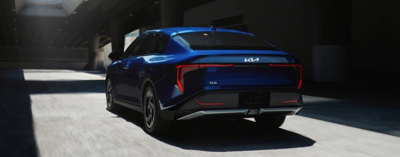 A blue 2025 Kia K4 driving through a tunnel.