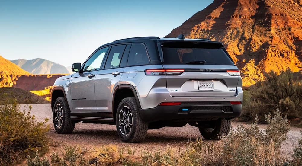 Rear of a silver 2025 Jeep Grand Cherokee L parked in a desert.