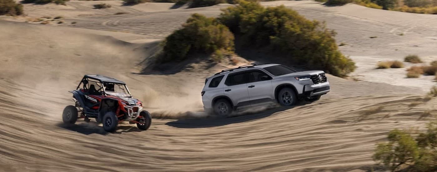 A white 2025 Honda Pilot off-roading.