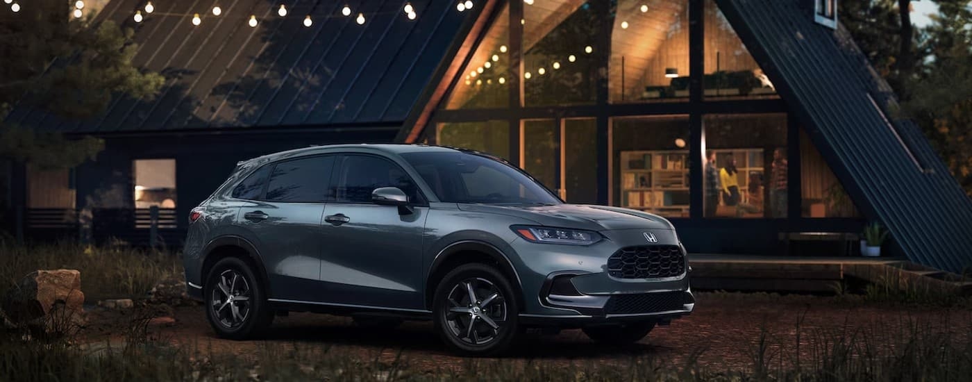 A silver 2024 Honda HR-V EX-L parked near a cabin.