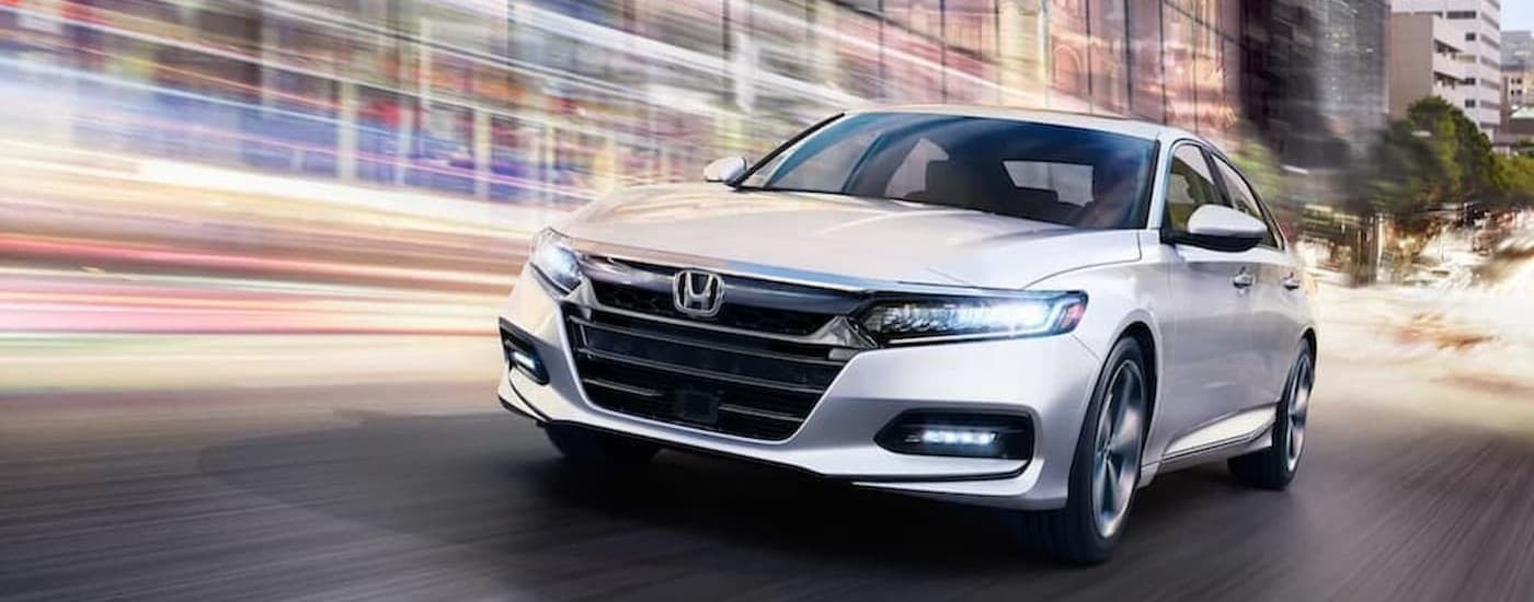 A white 2018 Honda Accord Touring driving to view a used Honda for sale near Hialeah.