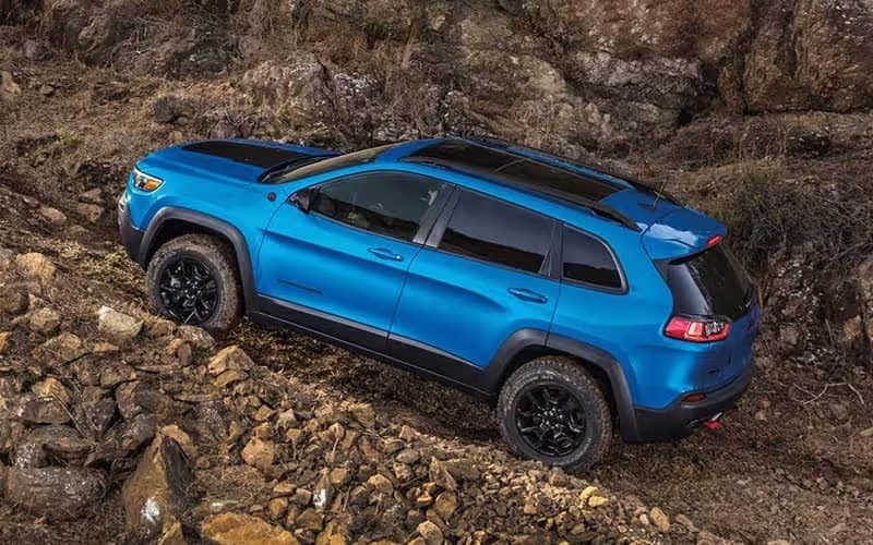 Blue Jeep Cherokee Climbing Rocks