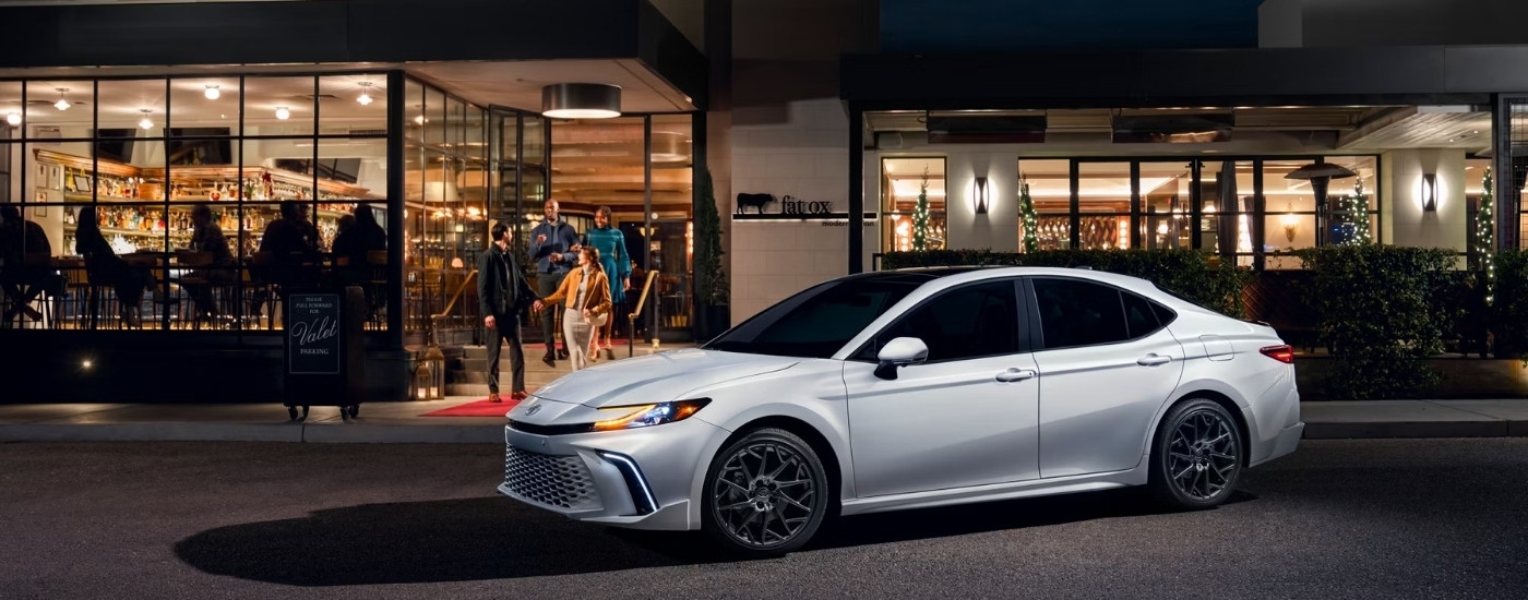 A white 2025 Toyota Camry for sale in Westminster from the side.