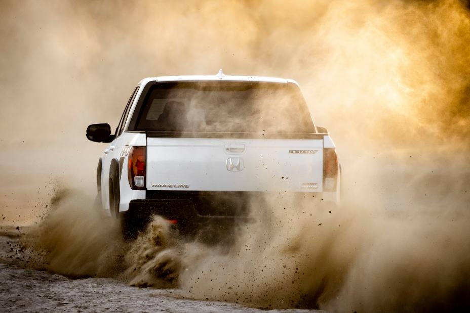 Rear view of the Honda Ridgeline driving through a desert road