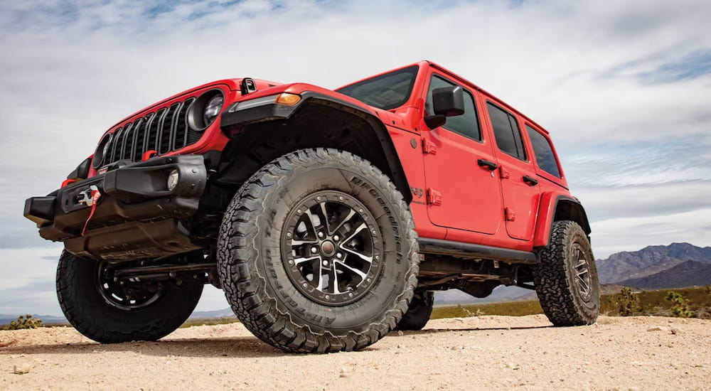 Red 2025 Jeep Wrangler for sale in Rhinebeck parked on sand.