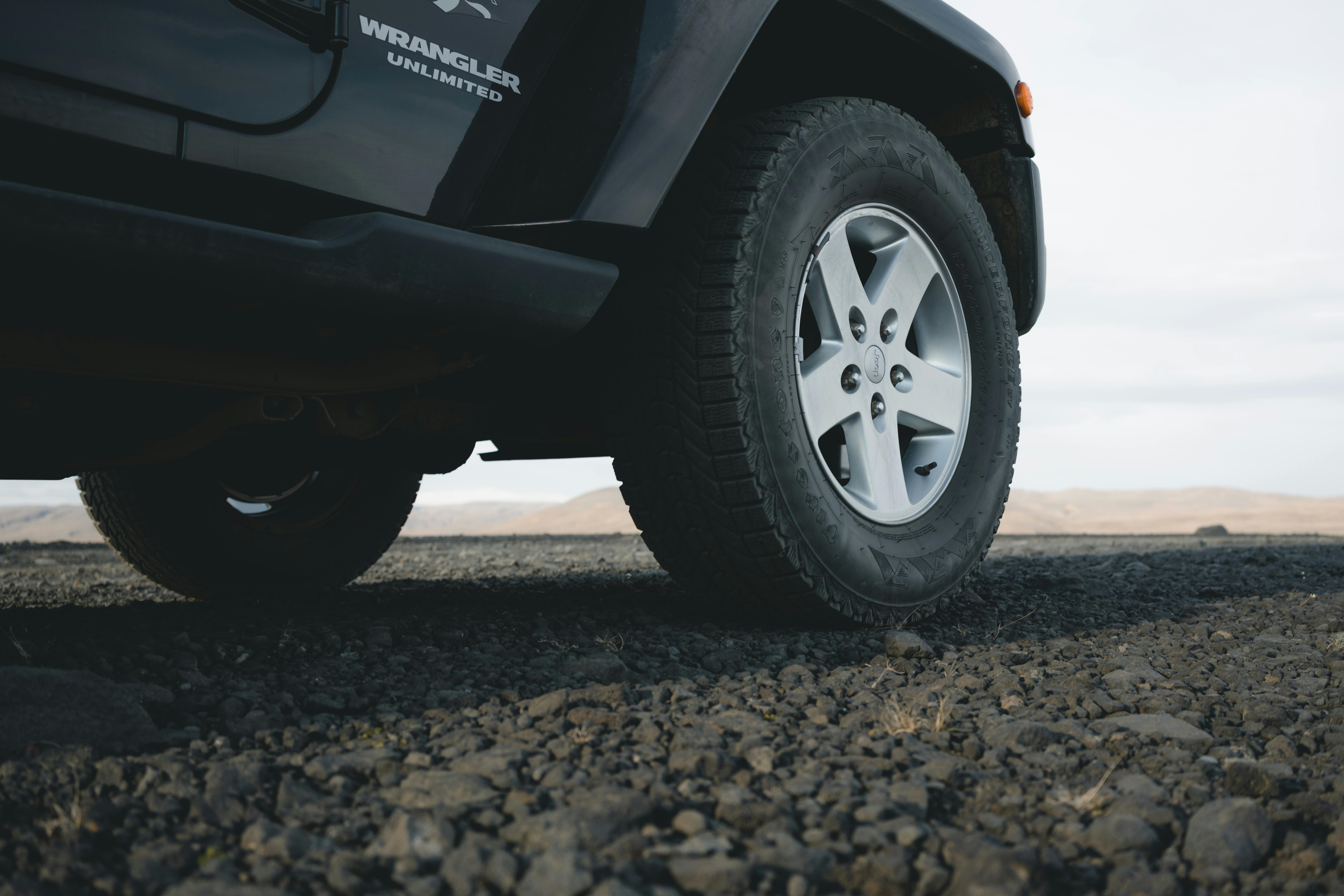 Ground-level view of the wheel on a Jeep Wrangler Unlimited overlooking the horizon