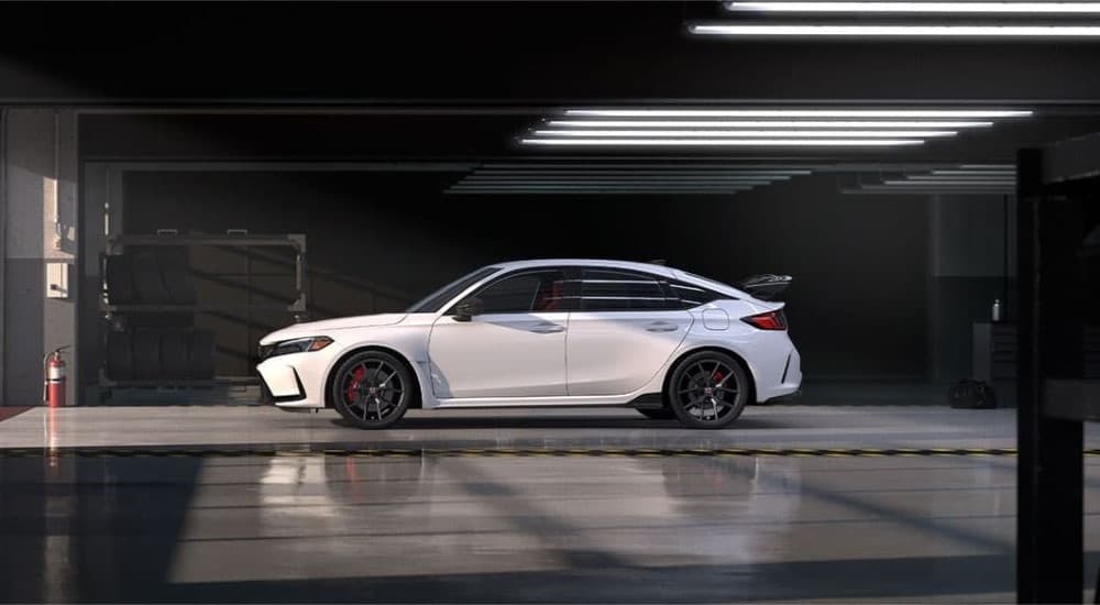 A white 2023 Honda Civic Type-R parked in a garage.