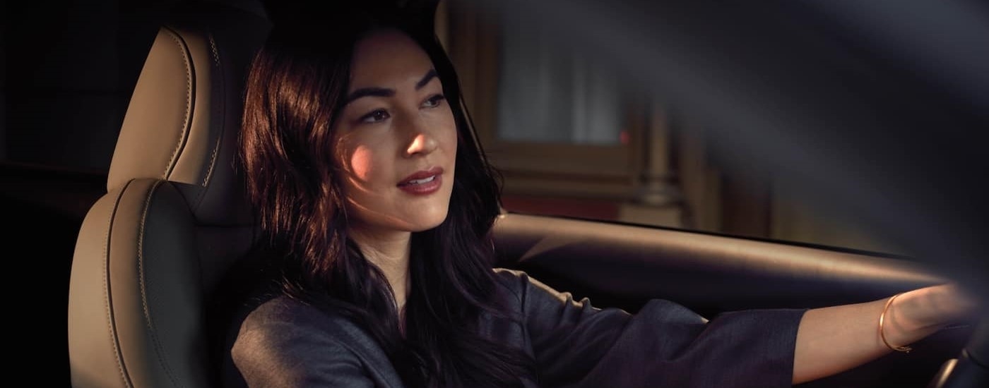 A woman driving in a 2025 Mazda CX-30 for sale near Hialeah.