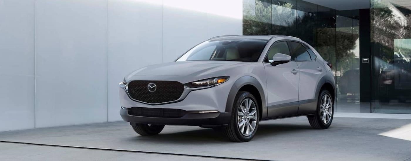 A gray 2025 Mazda CX-30 parked in a showroom.