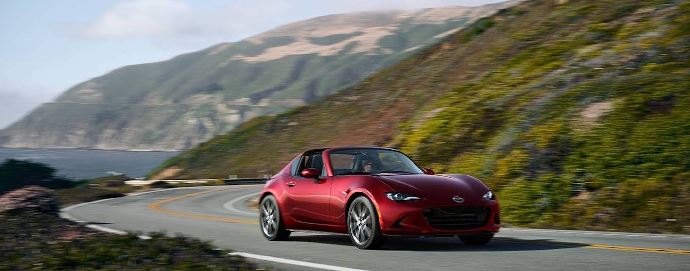 A red 2023 Mazda Miata RF from the front.