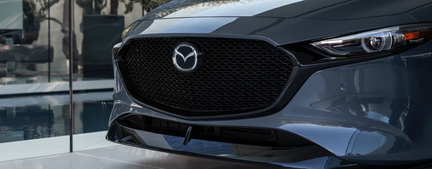 A grey 2021 Mazda3 from the front in close-up.