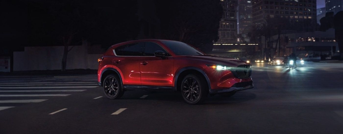 A red 2025 Mazda CX-5 for sale near Houston from the side.