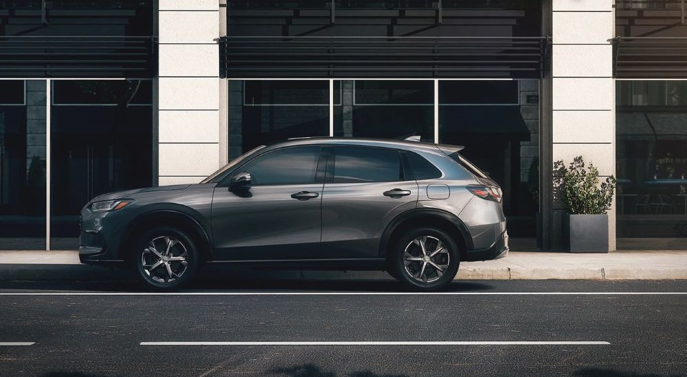 A gray 2023 Honda HR-V parked on a city street.
