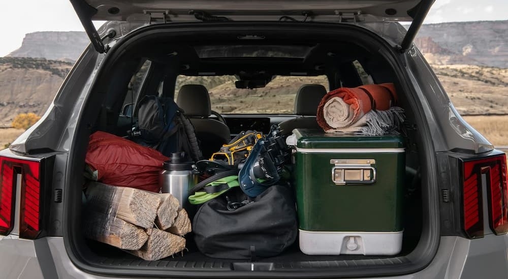 Camping gear in the rear cargo area of a silver 2025 Kia Sorento.