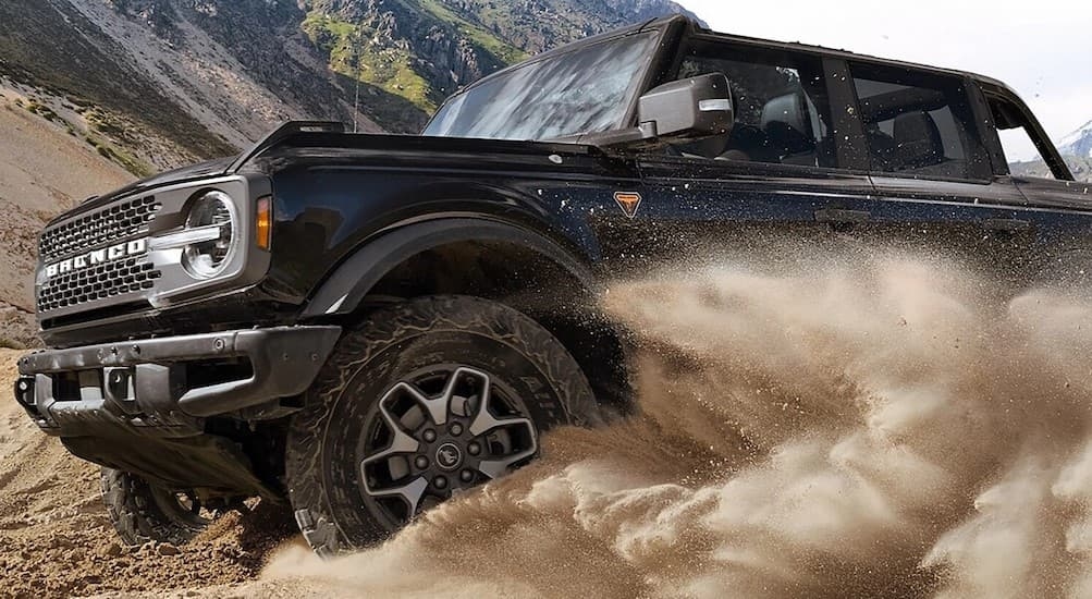 A black 2025 Ford Bronco for sale is off-roading.