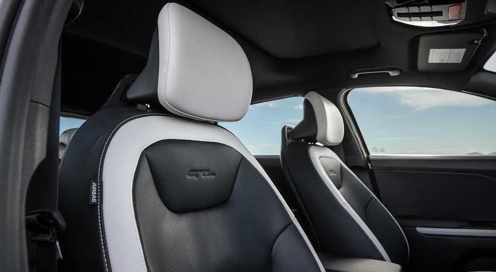 The black and white interior in a 2026 Kia K4 GT Hatchback.