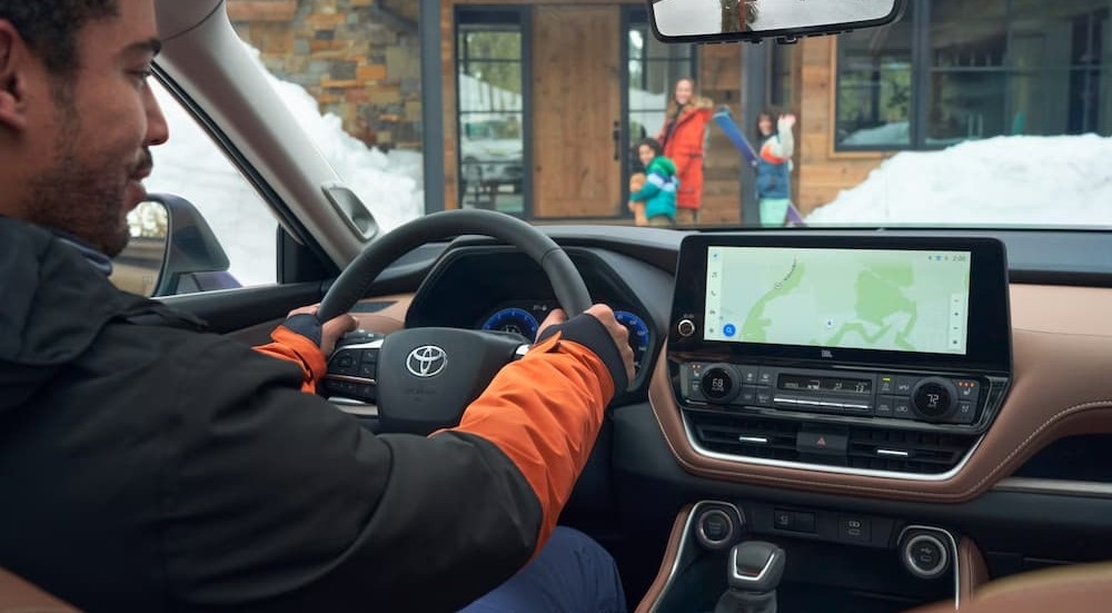 A person driving in a 2025 Toyota Grand Highlander.