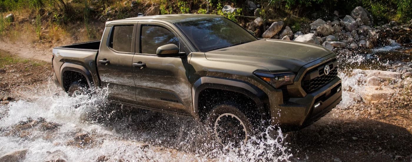 A green 2025 Toyota Tacoma off-roading.