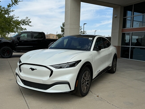 white 2025 Ford Mustang Mach-e electric SUV parked at the Chalmers Ford dealership in Albuquerque, NM