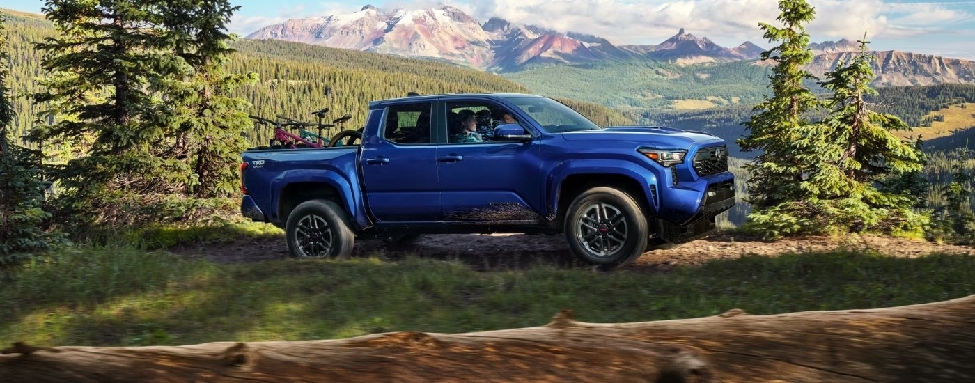 A blue 2025 Toyota Tacoma for sale near Brattleboro from the side.