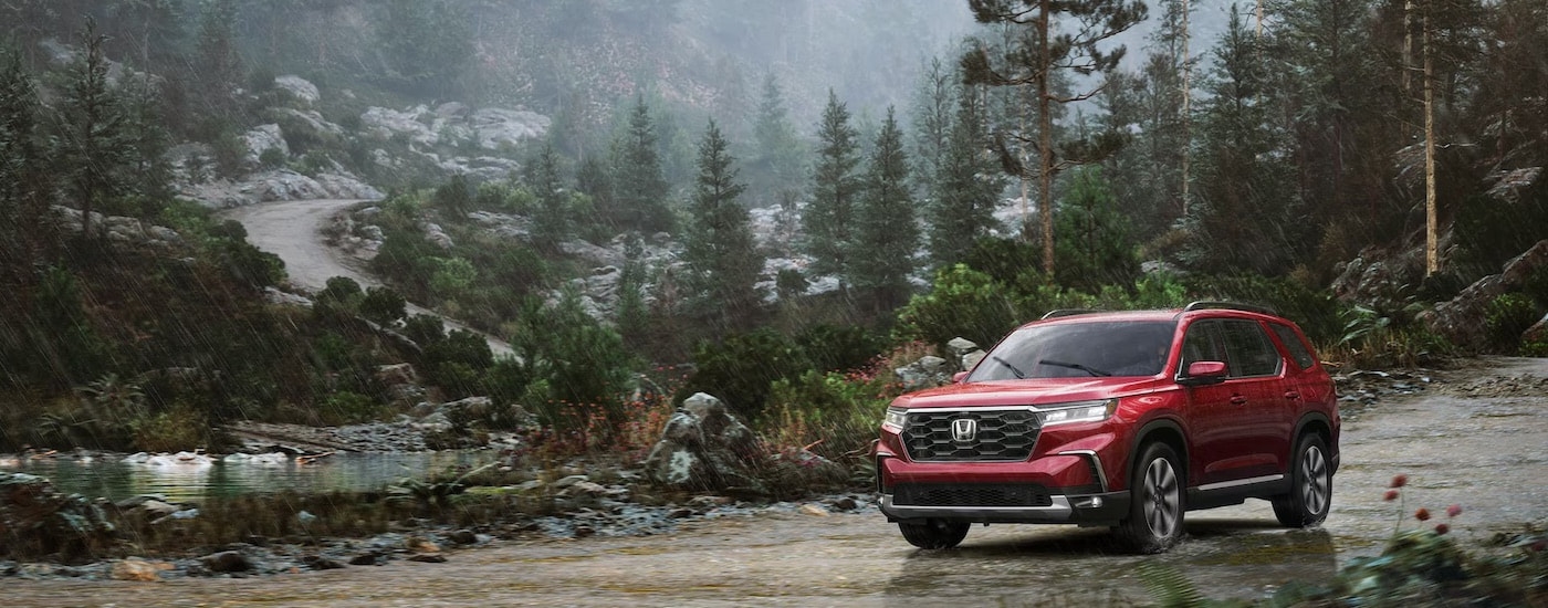 A red 2025 Honda Pilot for sale near Bellevue from the front at an angle.
