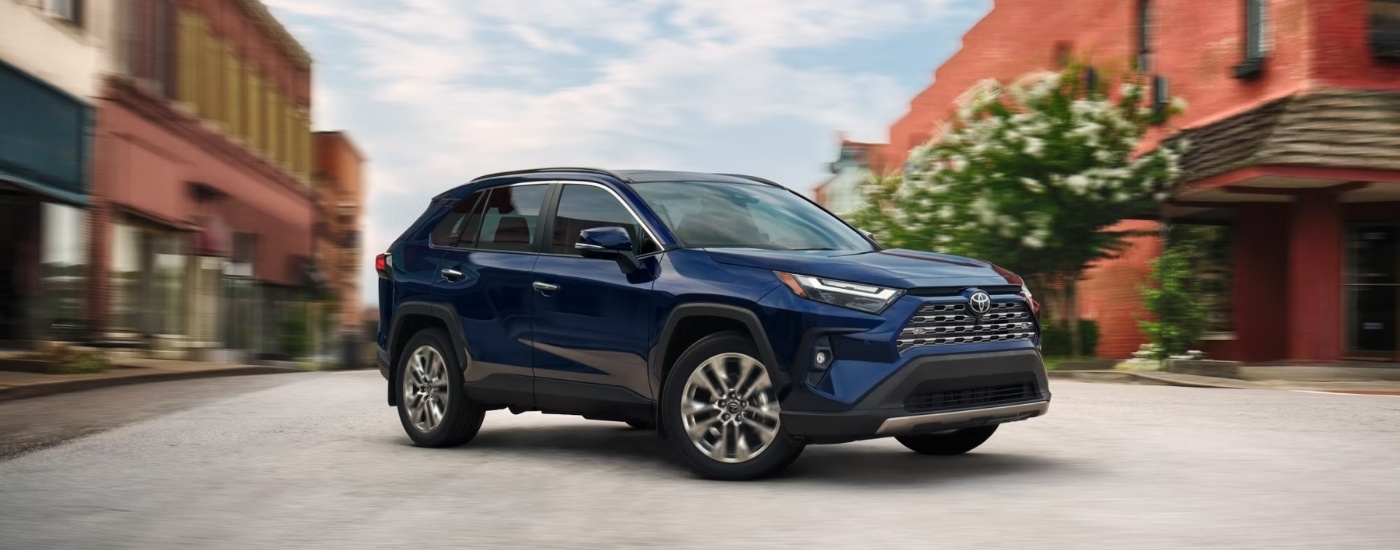 A blue 2025 Toyota RAV4 for sale near Ardsley from the side.