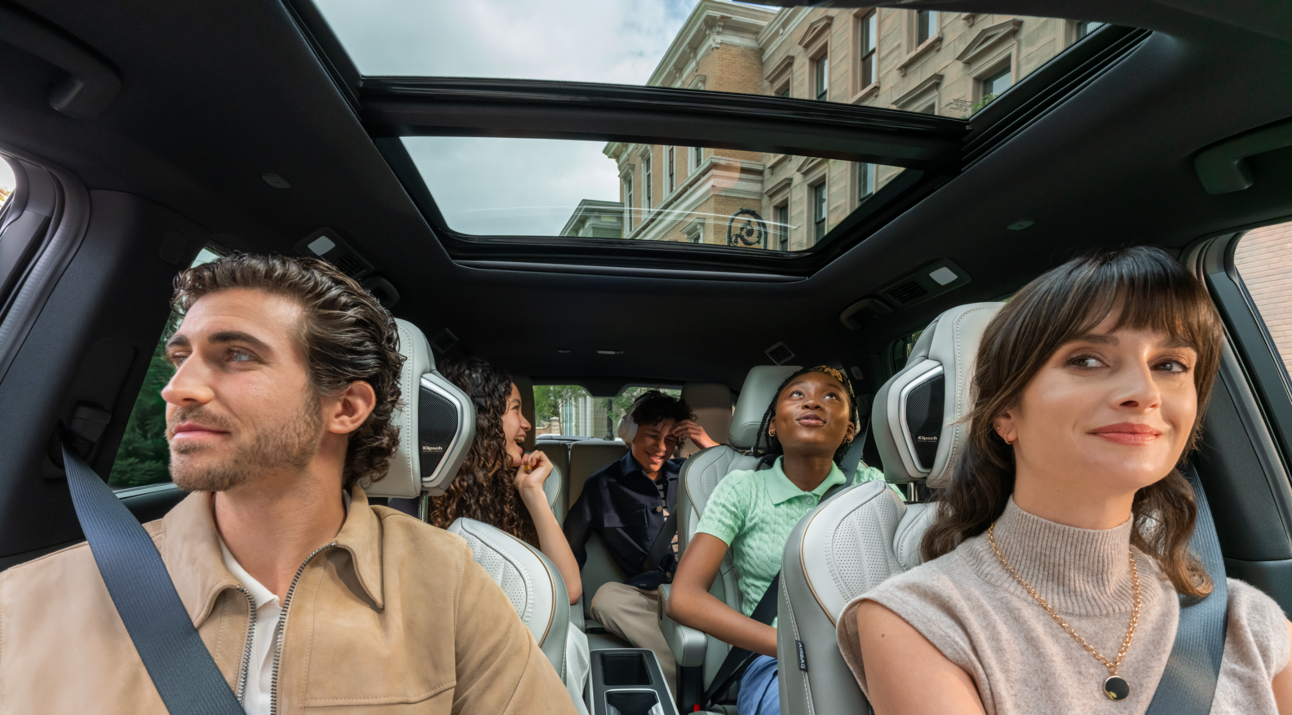 Family sitting in a Infiniti SUV