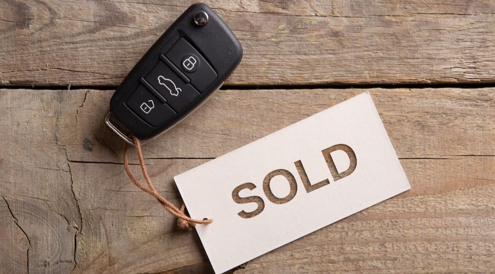 A sold tag strung to a key fob.