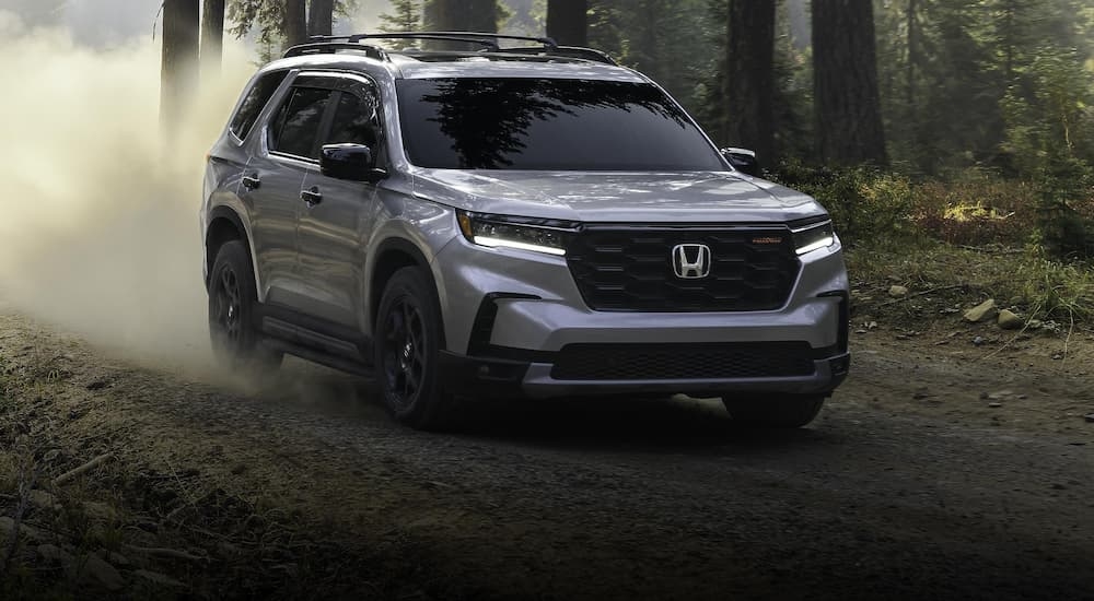 Grey 2025 Honda Pilot Trailsport for sale near Bellevue driving on a dirt road