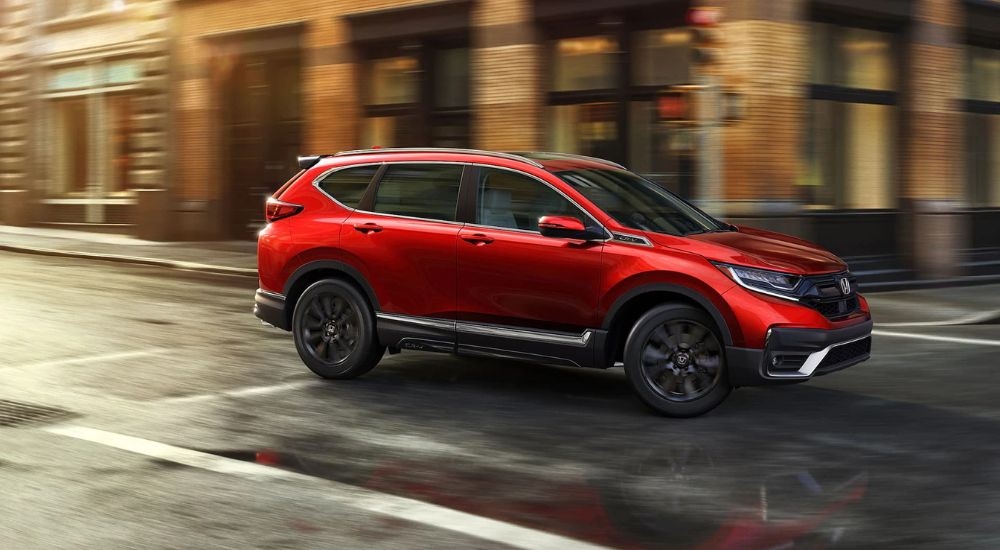 Red used 2021 Honda CR-V for sale driving near North Bergen