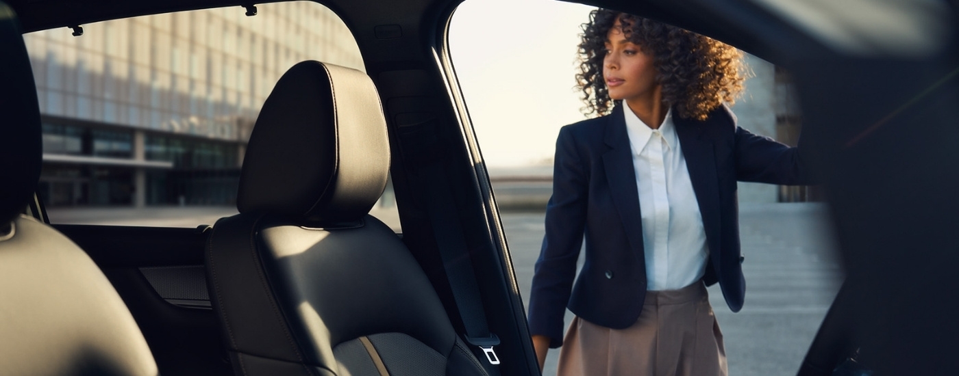 A person opening the door on a 2024 Mazda CX-90 PHEV.