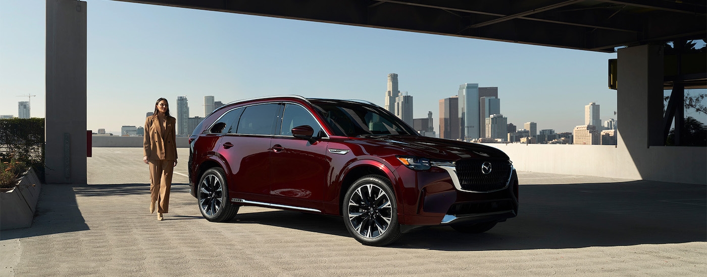 A maroon 2025 Mazda CX-90 for sale near Houston from the front.