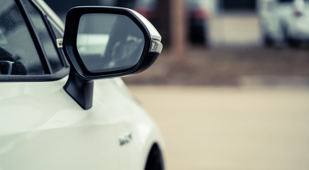 The side mirror on a white vehicle for sale