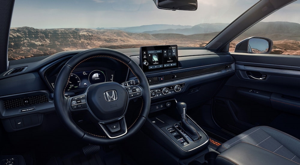 Black steering wheel, digital gauge cluster and infotainment screen in a 2026 Honda CR-V.